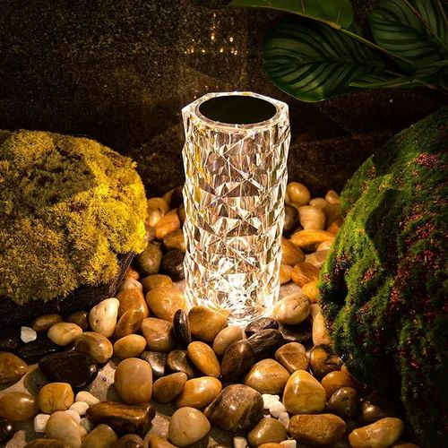 Crystal-like solar light on pebbles with natural background