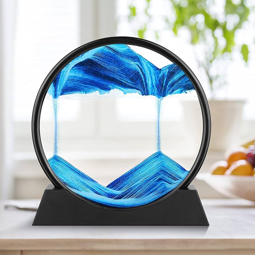 Decorative piece with blue and white abstract design on a black stand, set against a blurred indoor background.